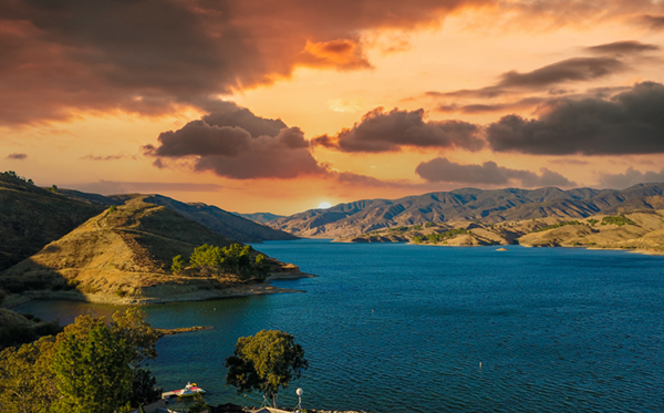 Castaic lake with majestic mountain ranges and powerful clouds at Castaic Lake Recreation Area in Castaic California.