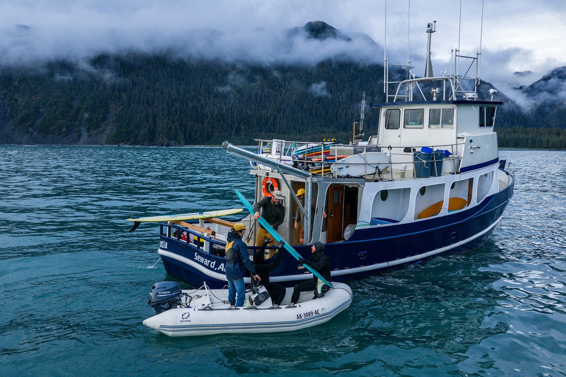 People on alaska surf boat