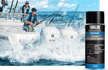 One man fishes off the back of the boat while two other men look on. In the foreground is a can of Yamalube Silicone Protectant & Lubricant.