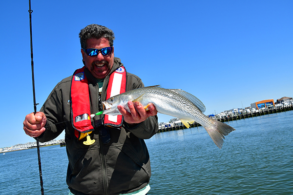 Businessman Catching Big Fish With Small Fish In Fishing Rod